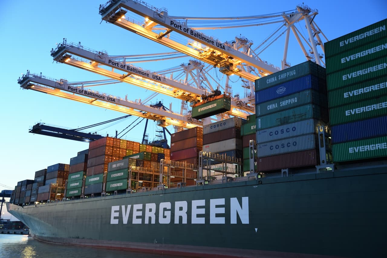 a large container ship with cranes