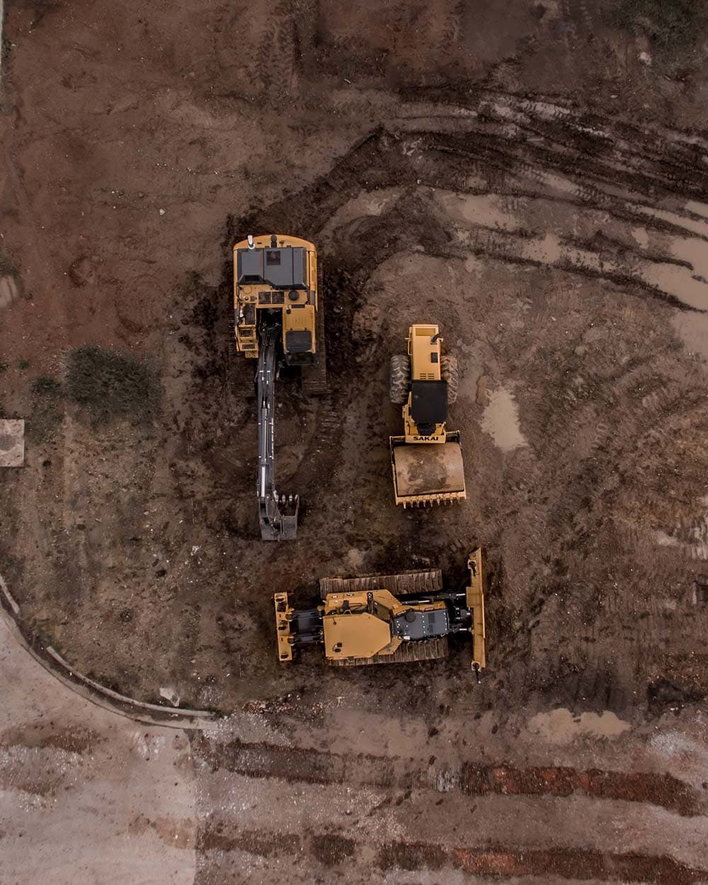 a group of construction vehicles in the dirt